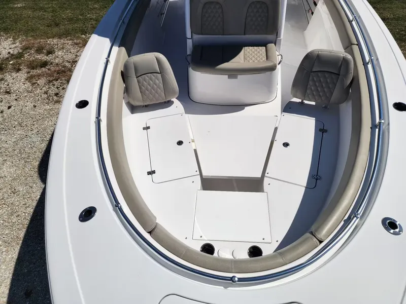 Slide: The Image of 2021 Sportsman 302 CC boat interior with cushioned seating and storage compartments. - 8