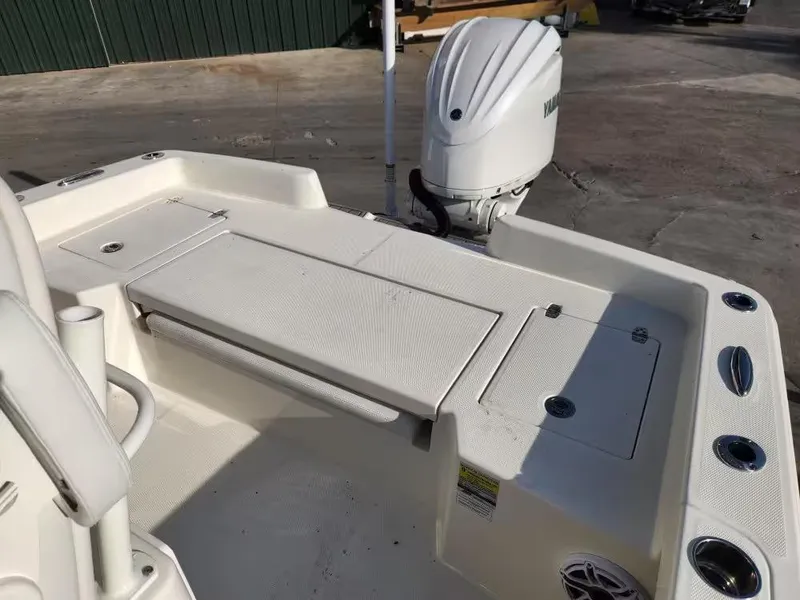 Slide: The Image of 2024 Pathfinder 2400 TRS boat deck with Yamaha outboard motor, featuring storage compartments. - 11