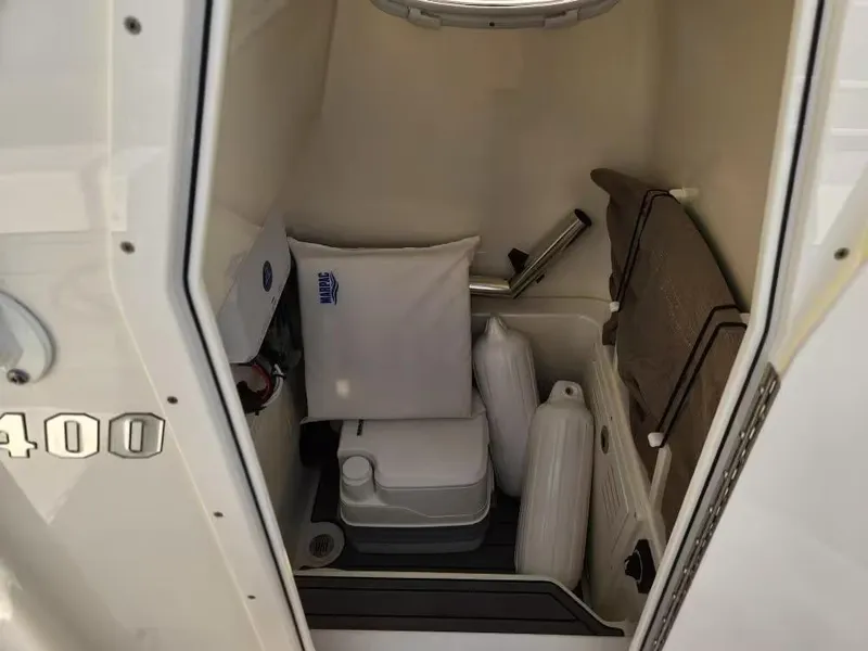 Slide: The Image of 2024 Pathfinder 2400 TRS boat interior storage with cushions and equipment. - 12