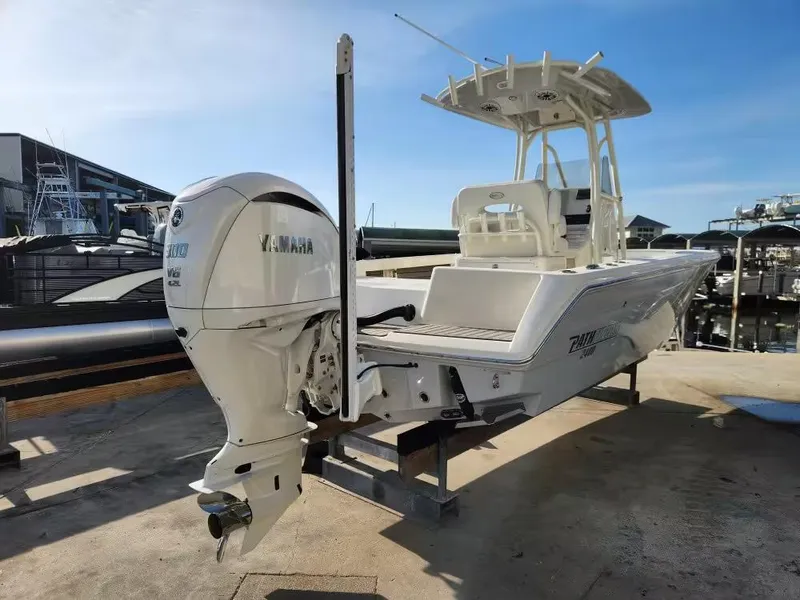 Slide: The Image of 2024 Pathfinder 2400 TRS boat with Yamaha engine, docked at marina under clear sky. - 3