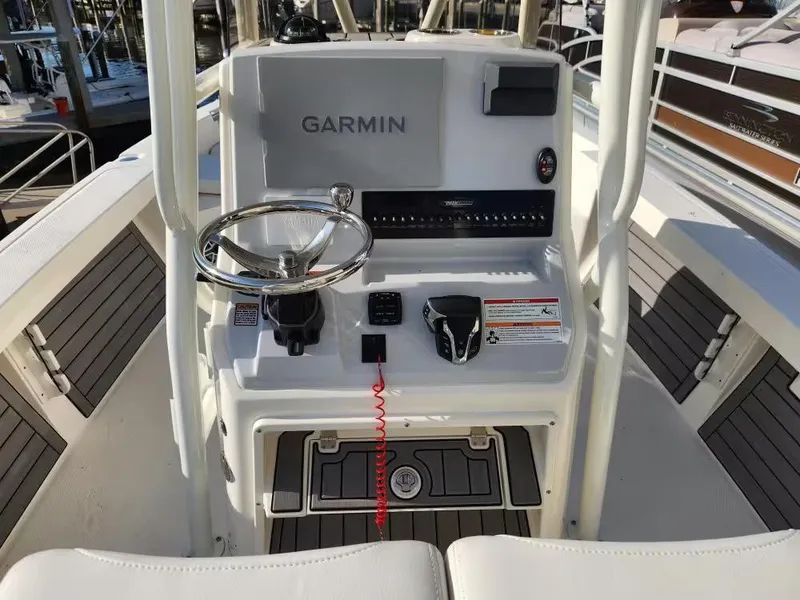 Slide: The Image of 2024 Pathfinder 2400 TRS boat console with Garmin navigation system and steering wheel. - 8