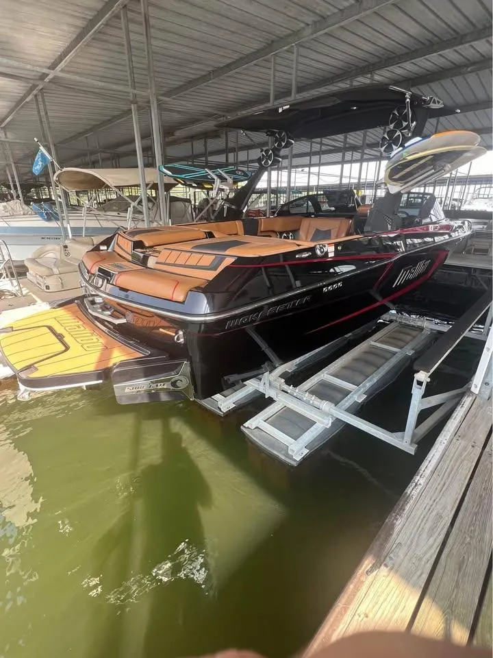 Slide: The Image of 2021 Malibu Wakesetter 23 MXZ boat docked in a covered marina. - 4