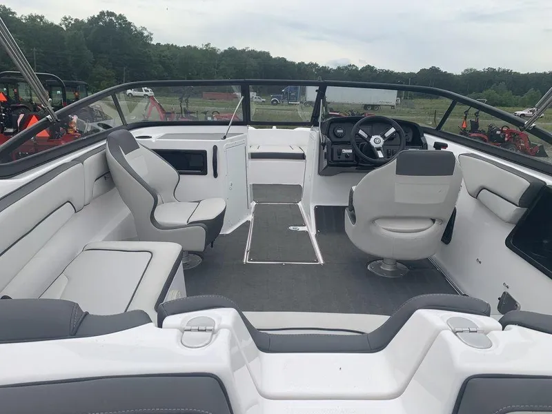Slide: The Image of 2021 Yamaha Boats SX190 interior with seating and steering wheel, set in a scenic outdoor location. - 3