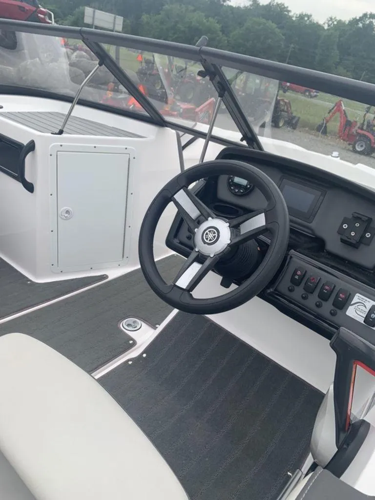 Slide: The Image of 2021 Yamaha Boats SX190 dashboard and steering wheel, featuring modern controls and sleek design. - 4