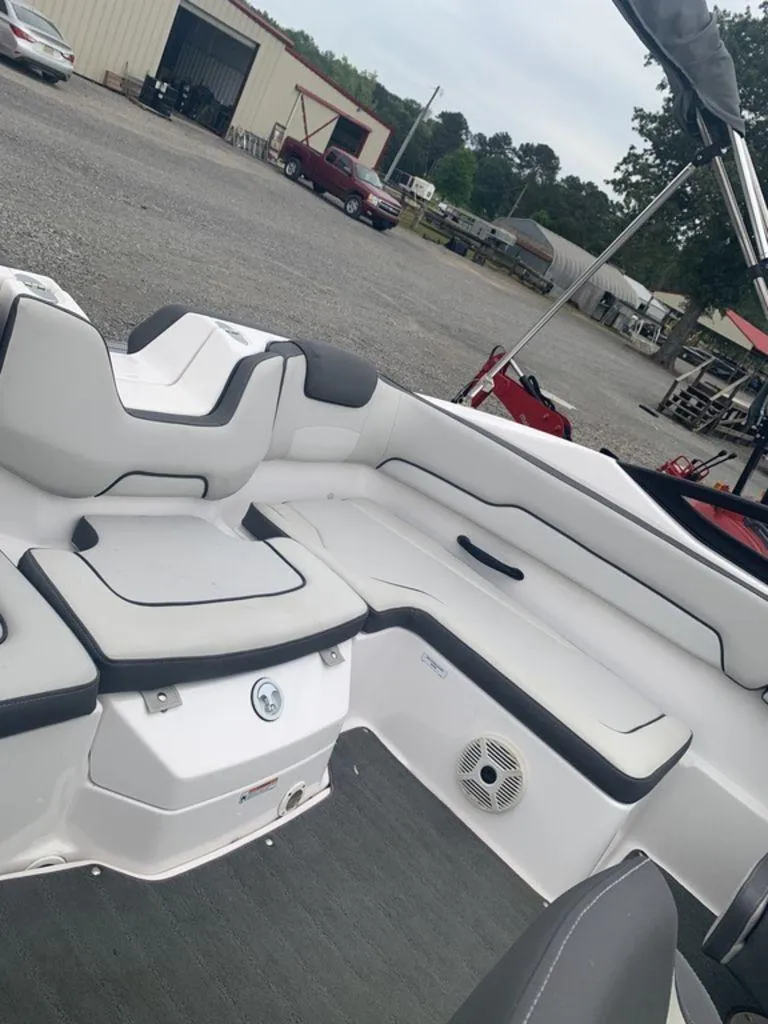 Slide: The Image of 2021 Yamaha Boats SX190 interior with white seating and storage compartments. - 6