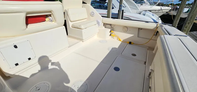 Slide: The Image of 1994 Tiara Yachts 3100 Open boat interior with seating and storage compartments. - 11