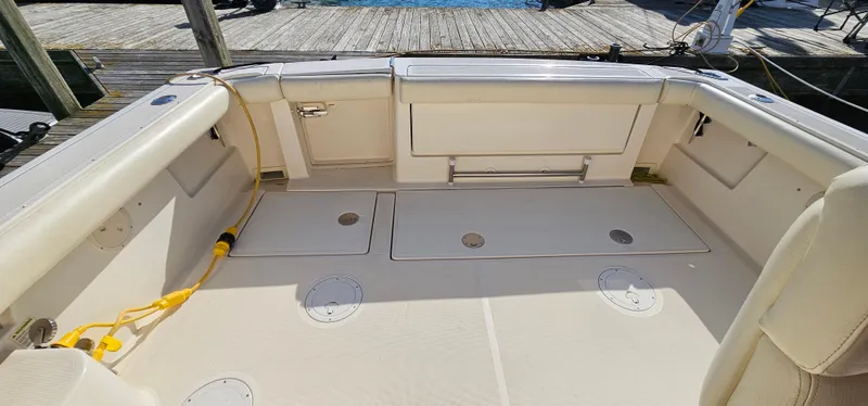 Slide: The Image of 1994 Tiara Yachts 3100 Open boat deck with storage compartments and seating. - 18
