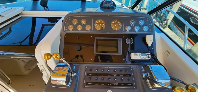 Slide: The Image of 1994 Tiara Yachts 3100 Open dashboard with gauges, controls, and navigation equipment. - 22