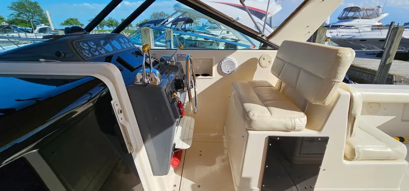 Slide: The Image of 1994 Tiara Yachts 3100 Open cockpit with beige seating and control panel. - 27