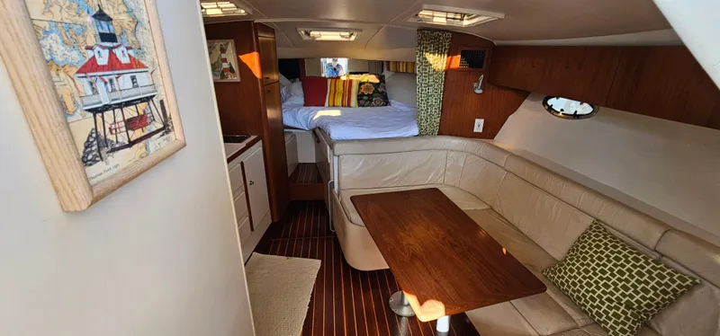 Slide: The Image of Interior of 1994 Tiara Yachts 3100 Open with cozy seating and wooden table. - 28