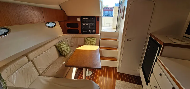 Slide: The Image of 1994 Tiara Yachts 3100 Open interior with seating, table, and steps. - 37