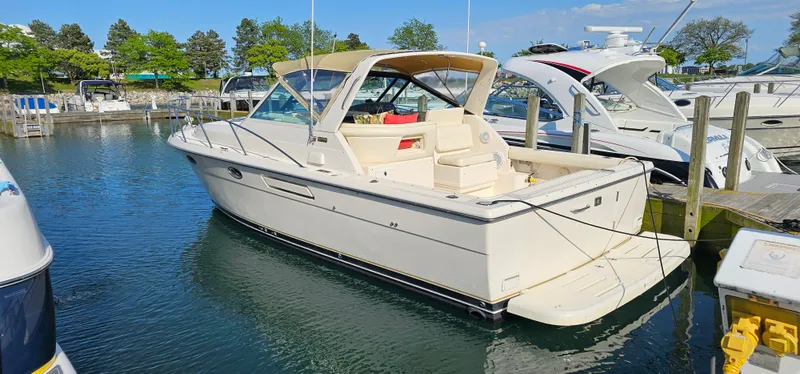 Slide: The Image of 1994 Tiara Yachts 3100 Open docked in a marina, surrounded by other boats. - 4