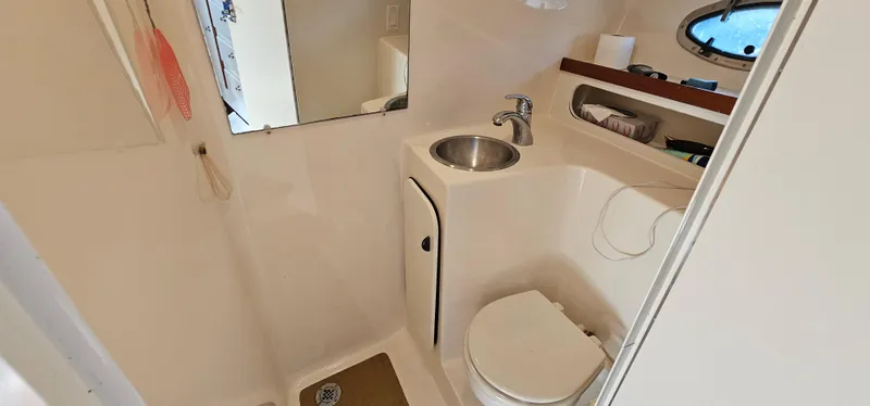 Slide: The Image of 1994 Tiara Yachts 3100 Open bathroom with sink, toilet, and mirror. - 40