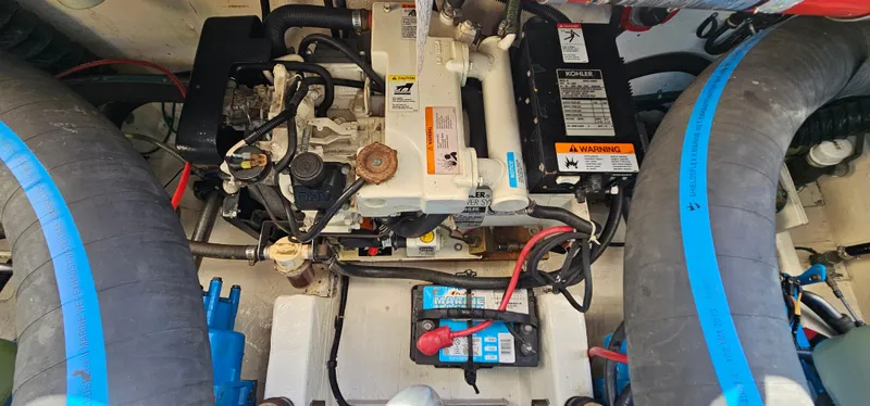 Slide: The Image of Engine compartment of a 1994 Tiara Yachts 3100 Open, showcasing mechanical components and wiring. - 42