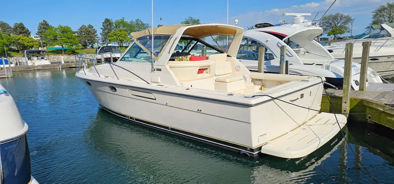 Slide: The Image of 1994 Tiara Yachts 3100 Open docked in a marina, surrounded by other boats. - 43