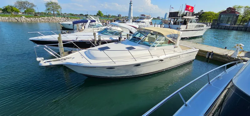 Slide: The Image of 1994 Tiara Yachts 3100 Open docked in a marina with other boats. - 44