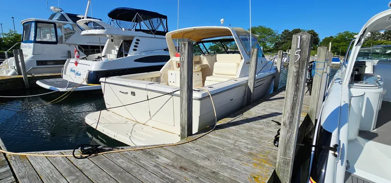 Slide: The Image of 1994 Tiara Yachts 3100 Open docked at marina, sunny day, clear blue sky. - 6