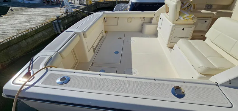 Slide: The Image of 1994 Tiara Yachts 3100 Open boat deck with seating and storage compartments. - 8