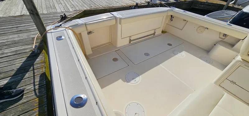 Slide: The Image of 1994 Tiara Yachts 3100 Open boat deck with storage compartments and seating. - 9