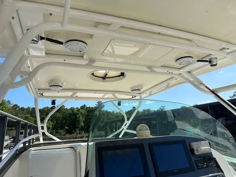 Slide: The Image of 2007 Hydra-Sports Vector 3300 VX boat interior with electronics and canopy structure. - 12