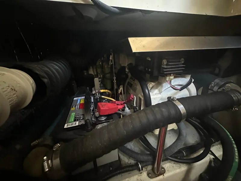 Slide: The Image of Engine compartment of a 2007 Hydra-Sports Vector 3300 VX boat, showing battery and hoses. - 25