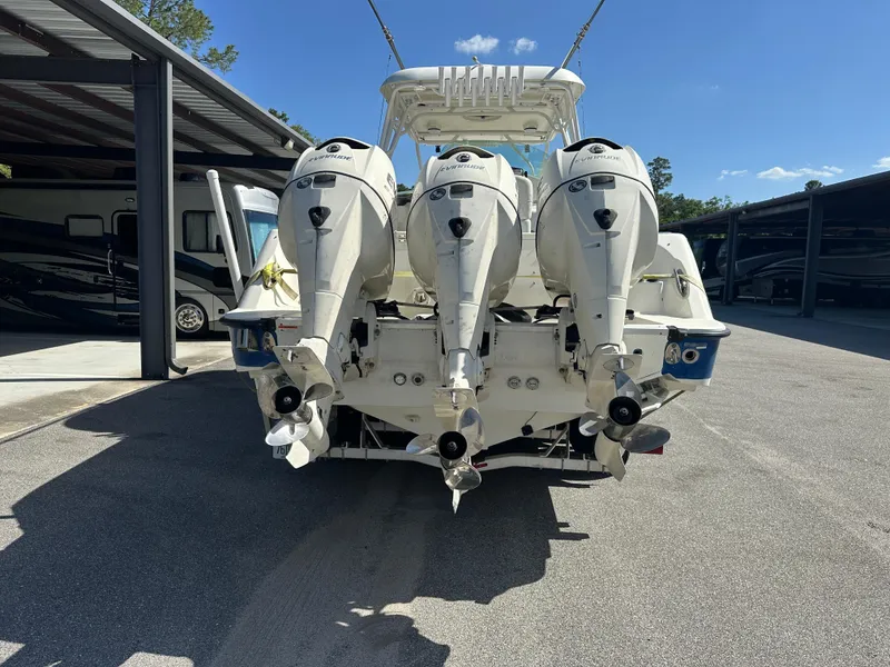 Slide: The Image of 2007 Hydra-Sports Vector 3300 VX boat with triple outboard engines, parked in a covered area. - 9