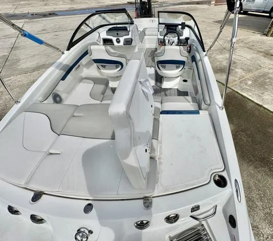 Slide: The Image of 2023 Tahoe 210 Si boat interior with white and blue seating, modern dashboard, and spacious layout. - 11