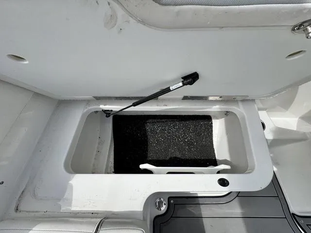 Slide: The Image of 2023 Tahoe 210 Si boat storage compartment with open lid and hydraulic support. - 17