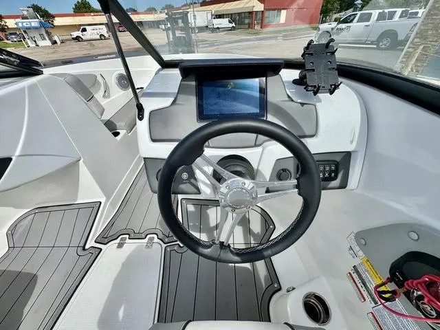 Slide: The Image of 2023 Tahoe 210 Si boat cockpit with steering wheel and digital display. - 18