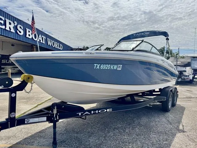 Slide: The Image of 2023 Tahoe 210 Si boat on trailer at dealer, under cloudy sky. - 3