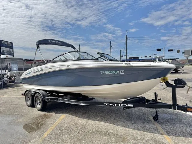 Slide: The Image of 2023 Tahoe 210 Si boat on trailer under a partly cloudy sky. - 5
