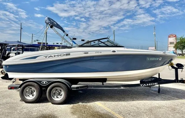 Slide: The Image of 2023 Tahoe 210 Si boat on trailer under blue sky. - 6