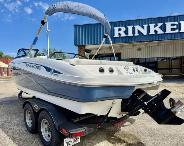 Slide: The Image of 2023 Tahoe 210 Si boat on trailer outside Rinker building, clear sky. - 9
