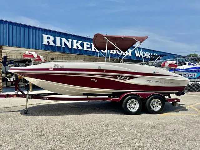 Slide: The Image of 2014 Tahoe 215 Xi boat on trailer, featuring sleek design and dual axles. - 1