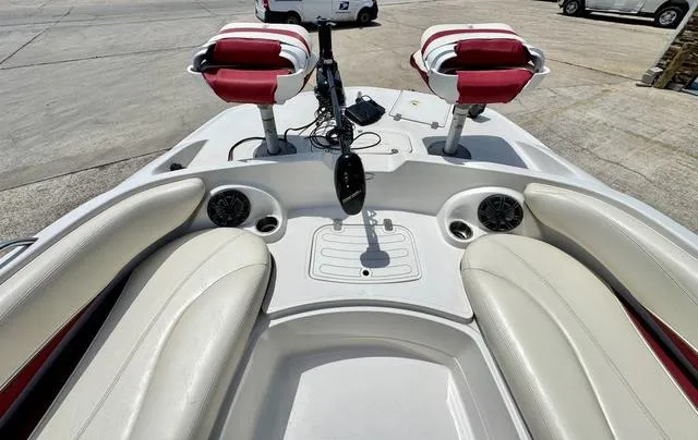 Slide: The Image of 2014 Tahoe 215 Xi boat interior with white and red seating, speakers, and control panel. - 13