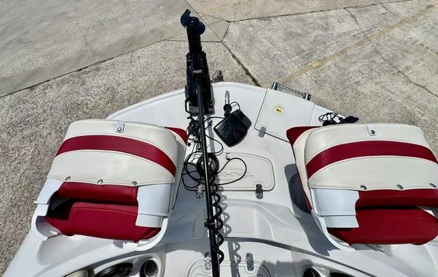 Slide: The Image of 2014 Tahoe 215 Xi boat interior with red and white seating, viewed from above. - 14