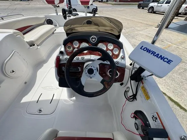 Slide: The Image of 2014 Tahoe 215 Xi boat dashboard with steering wheel and Lowrance navigation system. - 16