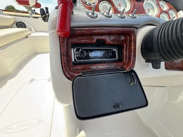 Slide: The Image of 2014 Tahoe 215 Xi boat dashboard with stereo system and gauges. - 17