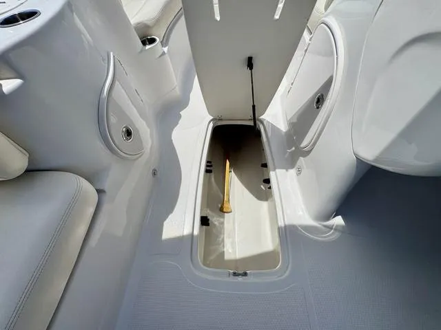Slide: The Image of 2014 Tahoe 215 Xi boat interior storage compartment with open hatch. - 19