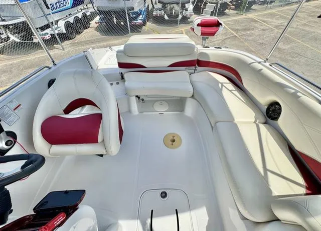 Slide: The Image of 2014 Tahoe 215 Xi boat interior with white and red seating, steering wheel, and spacious layout. - 20