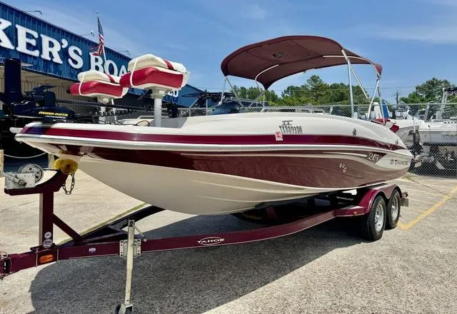 Slide: The Image of 2014 Tahoe 215 Xi boat on trailer, parked outdoors at a dealership. - 3
