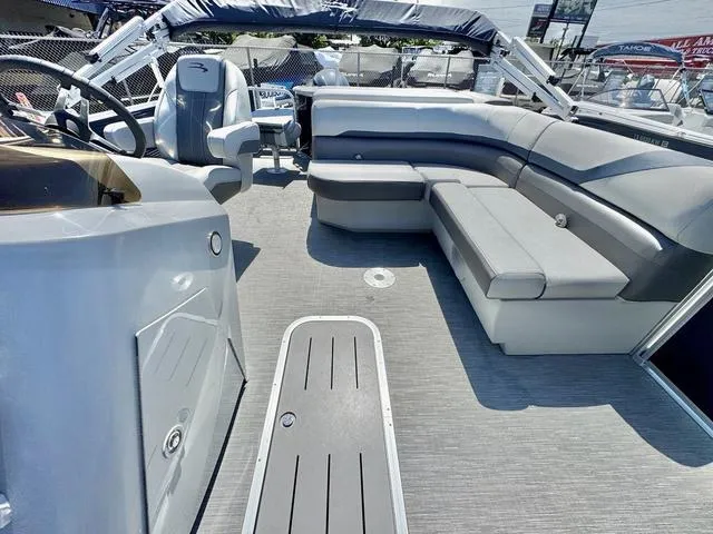 Slide: The Image of 2023 Bennington SX Fish 22 SXFAPG pontoon boat interior with gray seating and steering console. - 13
