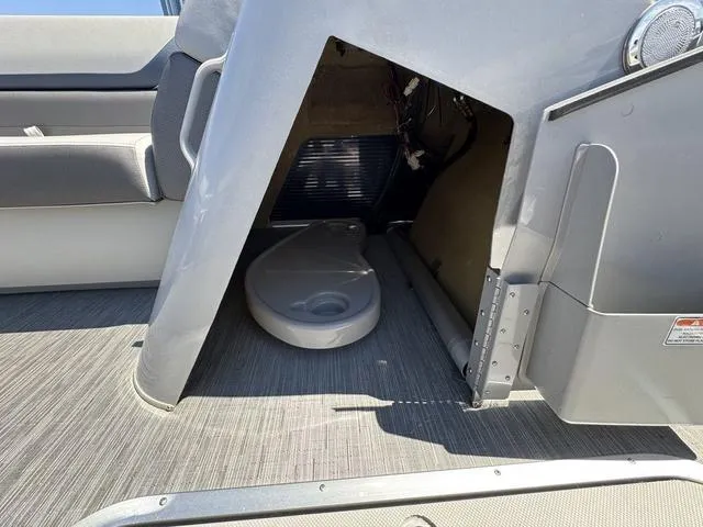 Slide: The Image of 2023 Bennington SX Fish 22 SXFAPG boat interior storage compartment with portable toilet. - 15