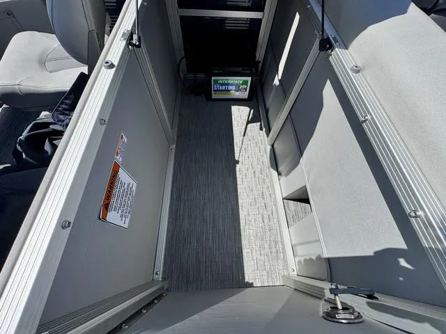 Slide: The Image of 2023 Bennington SX Fish 22 SXFAPG interior with storage compartment and battery. - 21