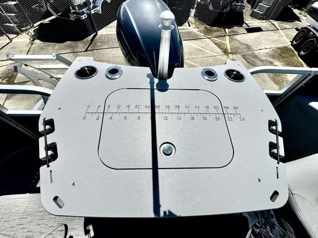 Slide: The Image of 2023 Bennington SX Fish 22 SXFAPG boat deck with fishing rod holders and measurement guide. - 22