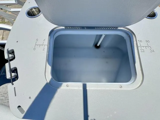 Slide: The Image of 2023 Bennington SX Fish 22 SXFAPG livewell with open lid and measurement markings. - 23