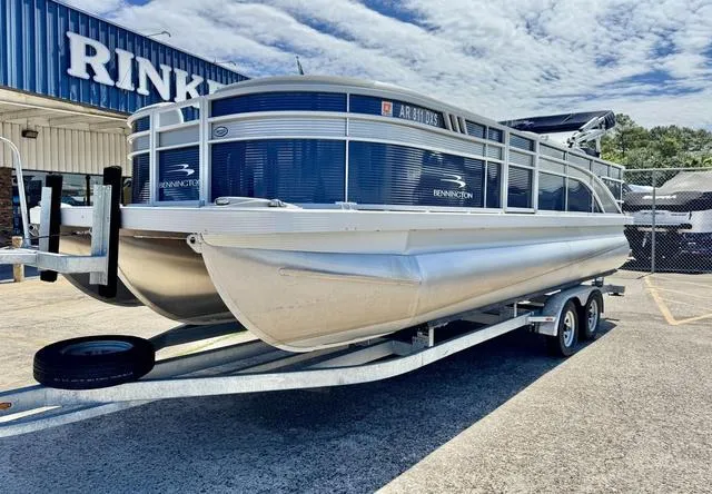 Slide: The Image of 2023 Bennington SX Fish 22 SXFAPG pontoon boat on a trailer, parked outdoors. - 3