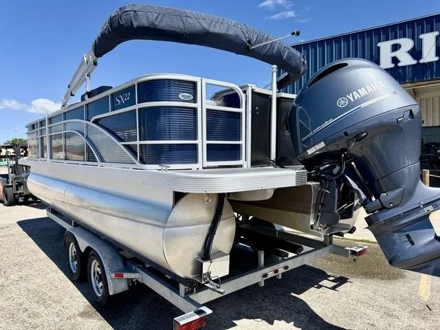 Slide: The Image of 2023 Bennington SX Fish 22 SXFAPG pontoon boat with Yamaha outboard motor on trailer. - 4