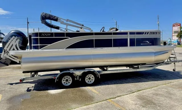Slide: The Image of 2023 Bennington SX Fish 22 SXFAPG pontoon boat on trailer in parking lot. - 7