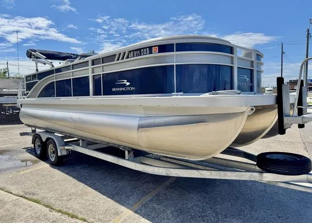 Slide: The Image of 2023 Bennington SX Fish 22 SXFAPG pontoon boat on trailer, parked outdoors. - 8